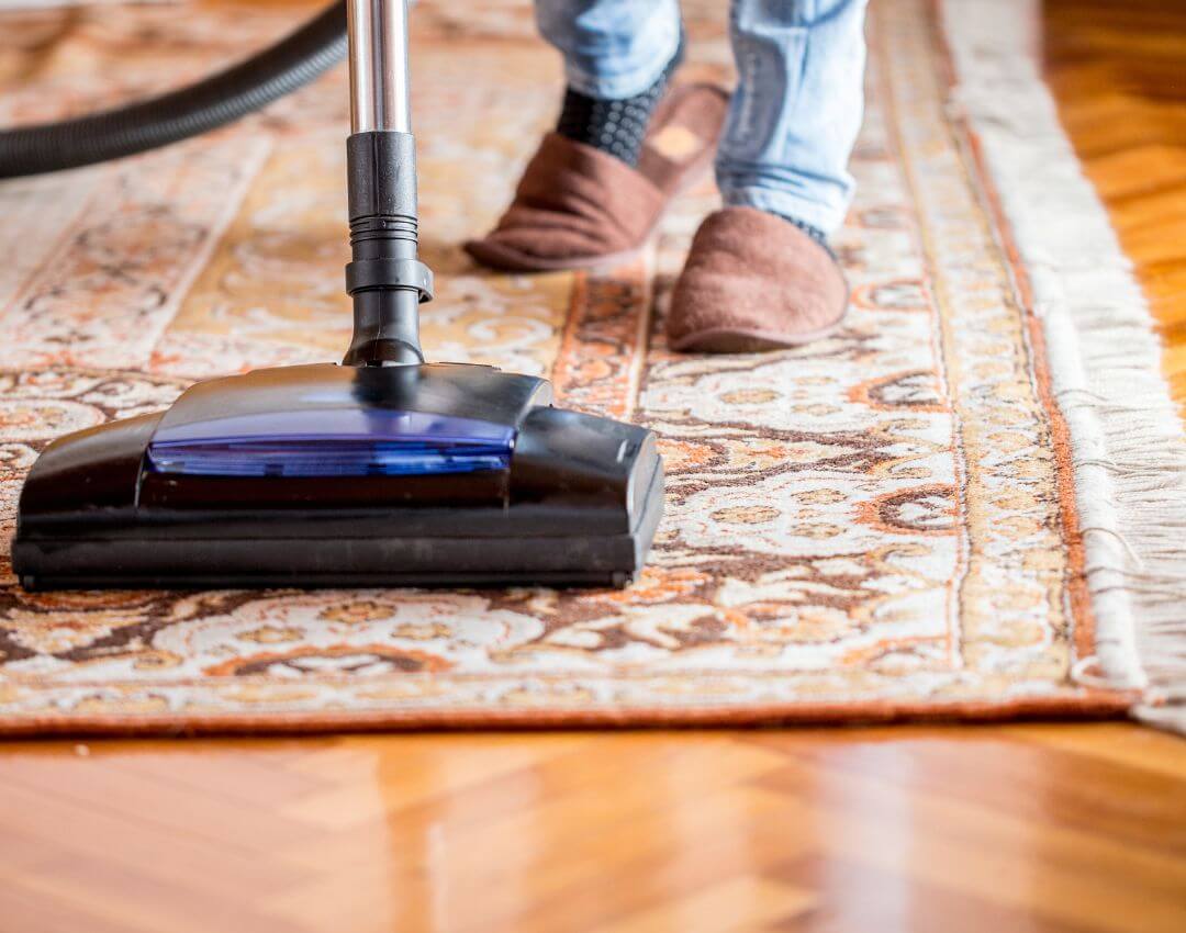 carpet with fringe being vacuumed