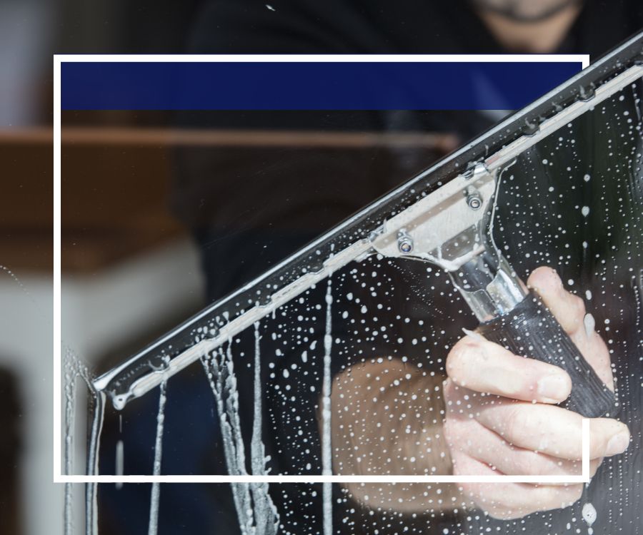 cleaning window with squeegee