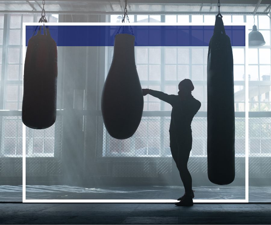 woman using punching bag in gym