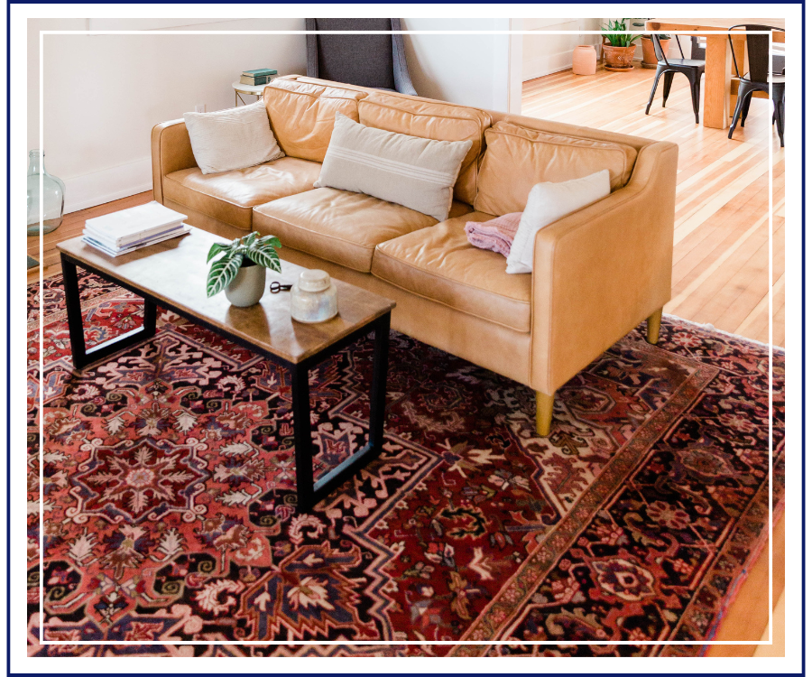 A beautifully preserved family heirloom rug is displayed prominently in a welcoming living room setting.