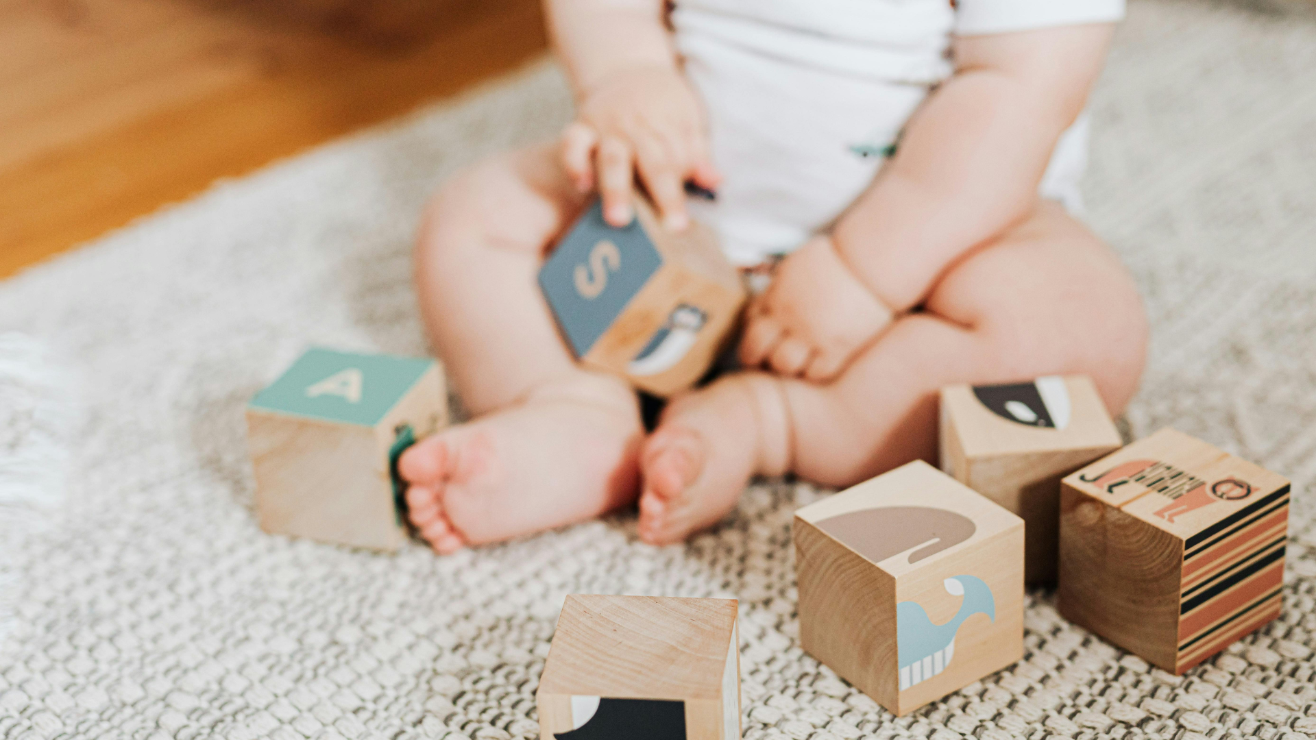 baby sitting on area rug